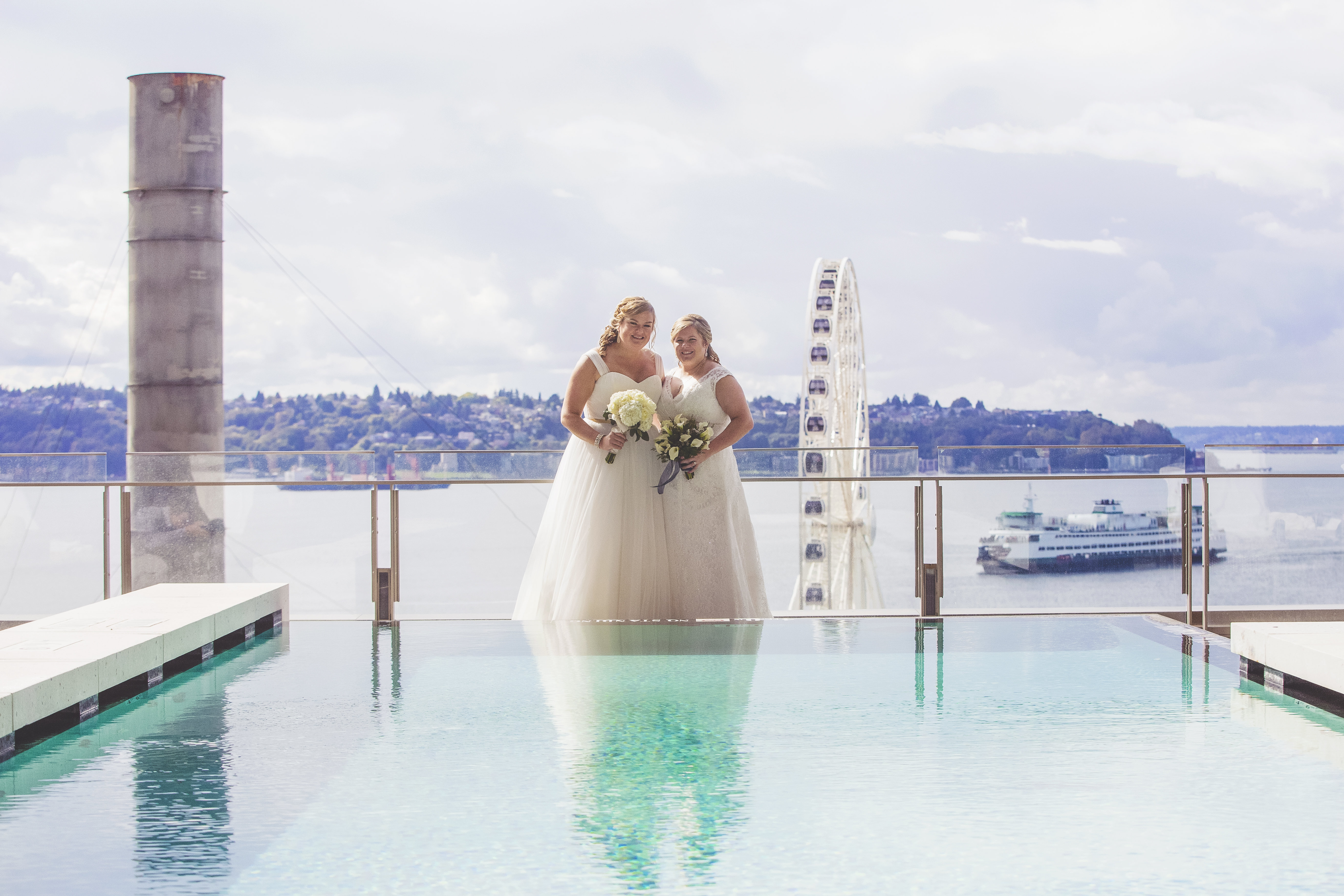 Four Seasons Seattle Wedding | Seattle Great Wheel, Four Seasons Pool same sex couple photo | Perfectly Posh Events, Seattle Wedding Planner | Josh Lewis Photography